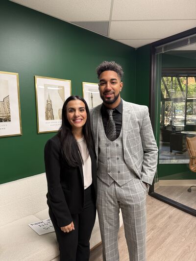 Two team members by a gallery wall