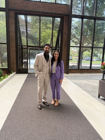 Two team members outside an office