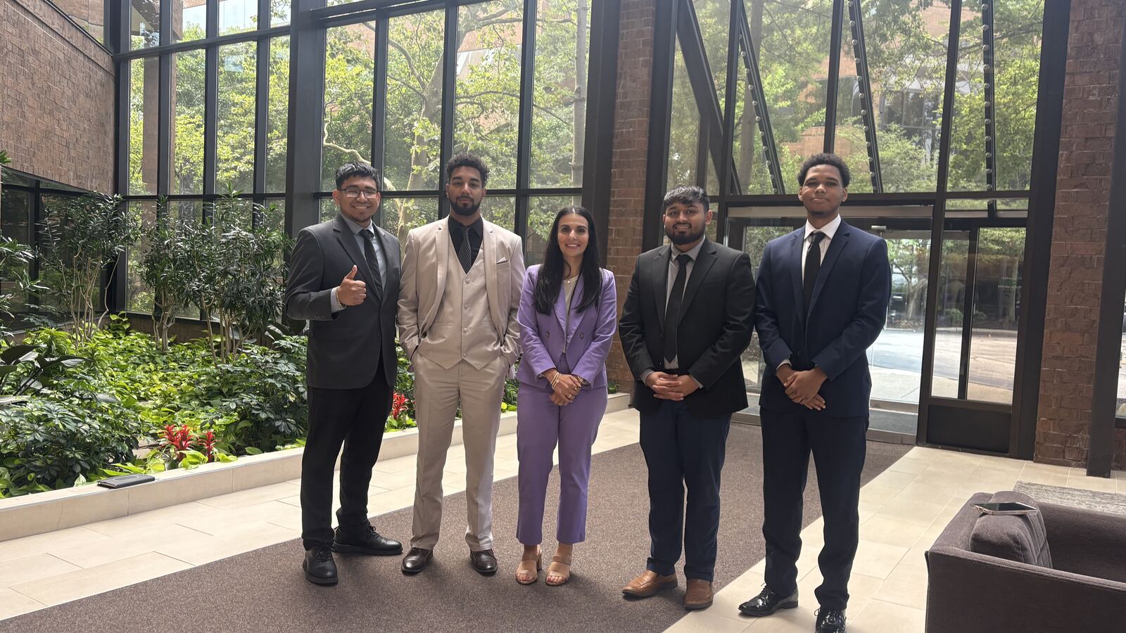 The Consistency Collective team gathered in a bright Long Island office