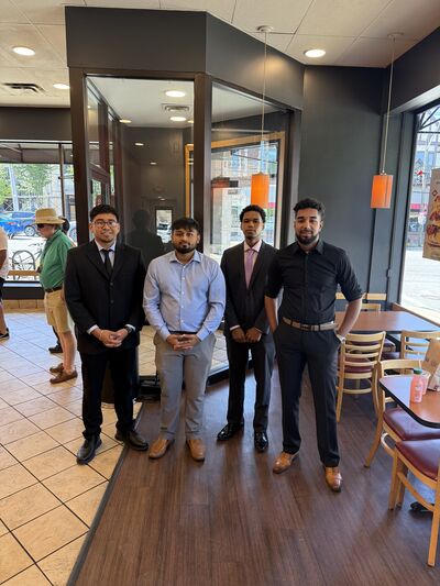 Four team members standing together