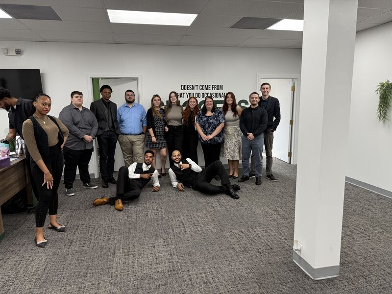 The full Consistency Collective team smiling together in the office